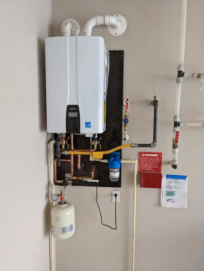 Professional plumber installing copper piping in a Bono home